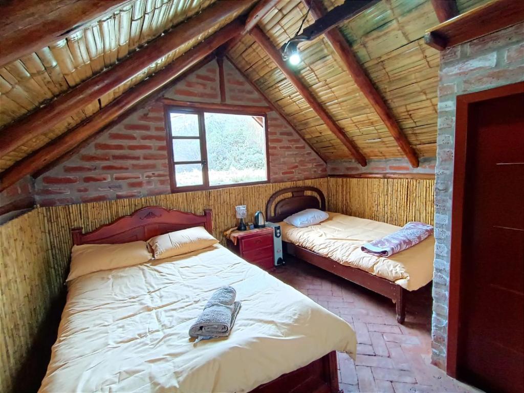 a bedroom with two beds in a attic at Chimborazo Basecamp in Chimborazo