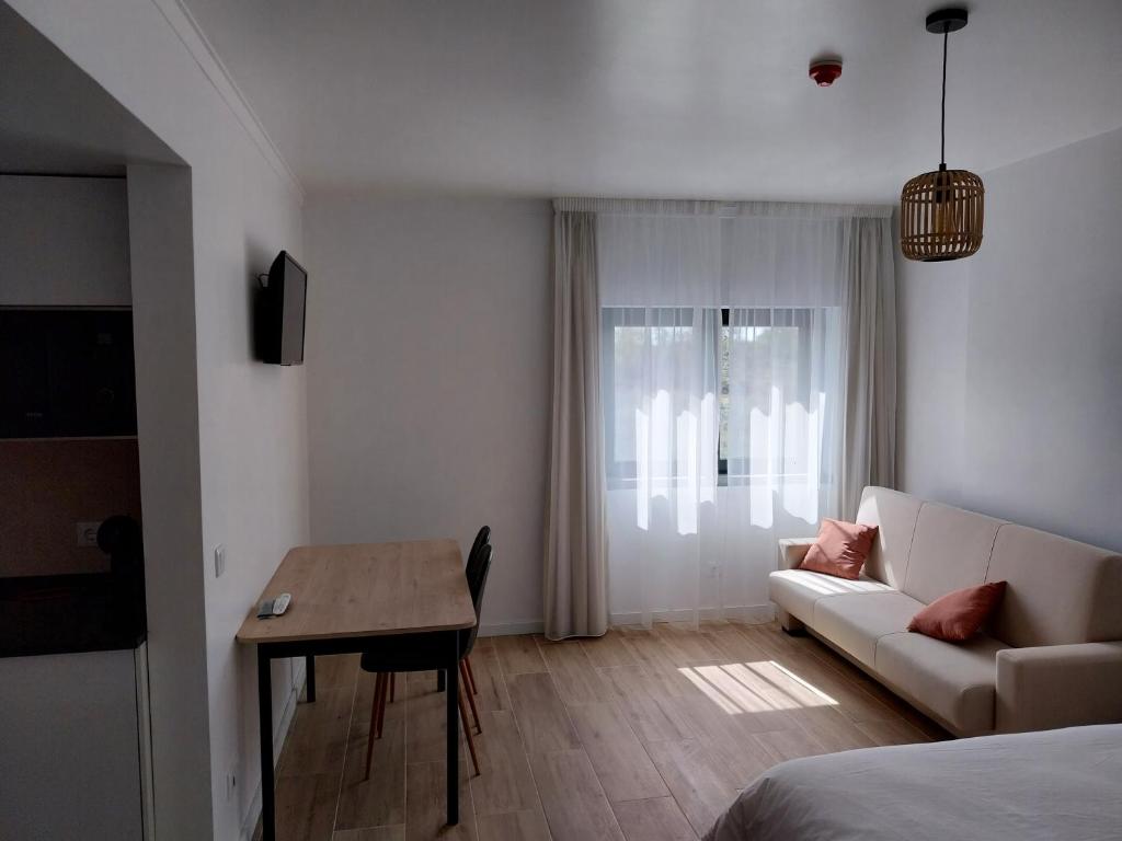 塞辛布拉的住宿－Casa das Vinhas，客厅配有沙发和桌子