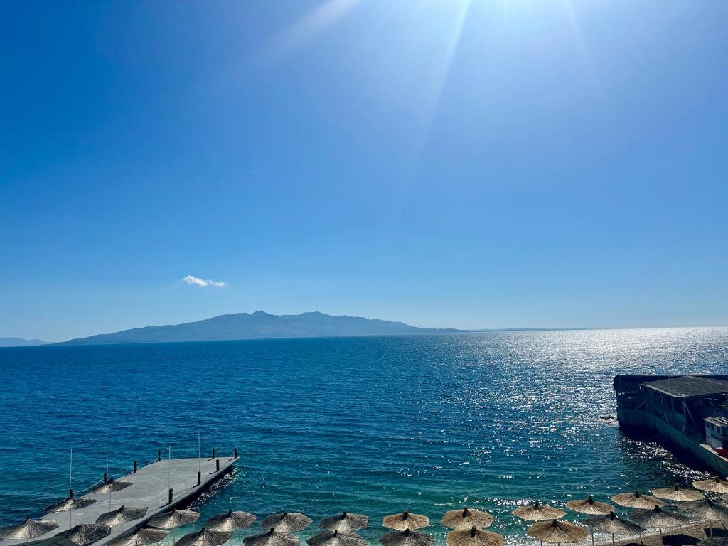 a large body of water with a pier in it at SHEMO Apartments in Sarandë