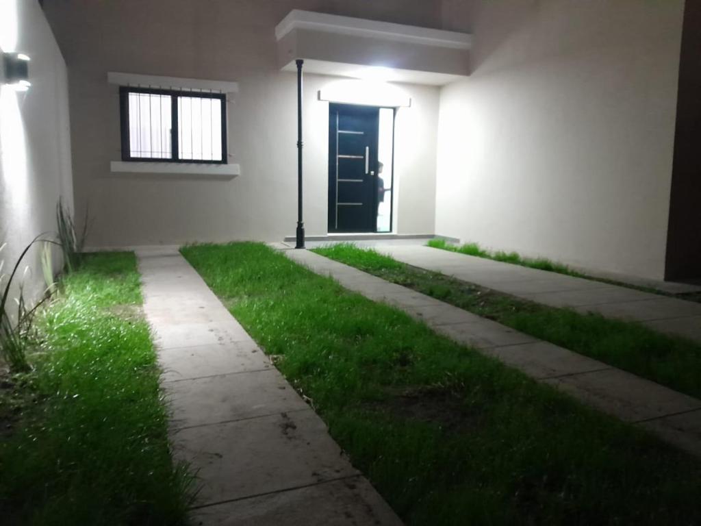 a room with green grass and a door at La Ruperta in Mercedes