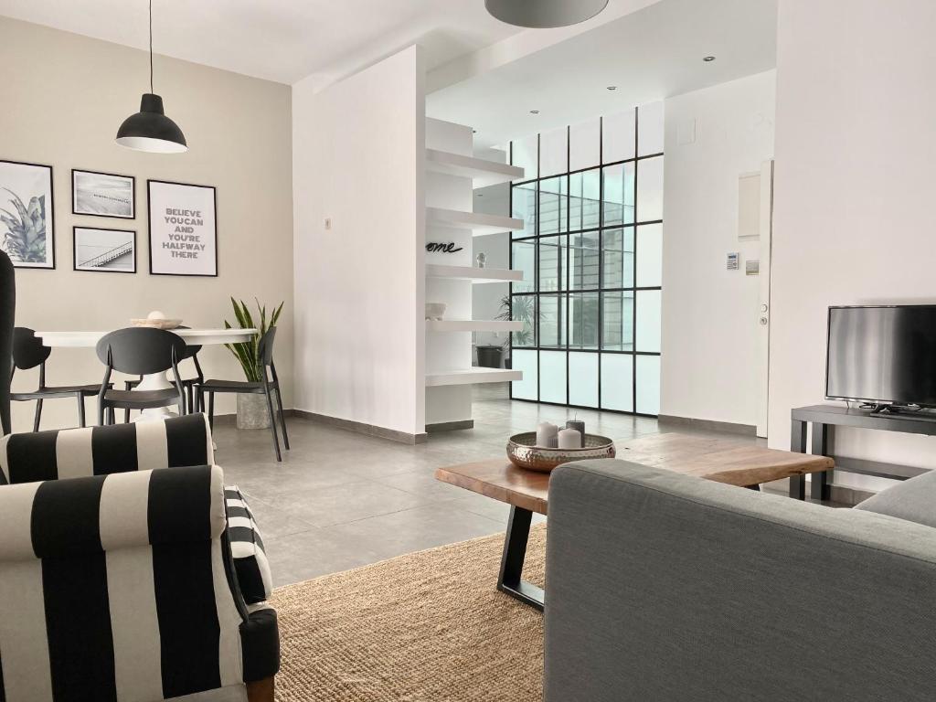 a living room with a couch and a table at Central, spacious and bright 2-bedroom apartment By Estio Comfort Living in Heraklio