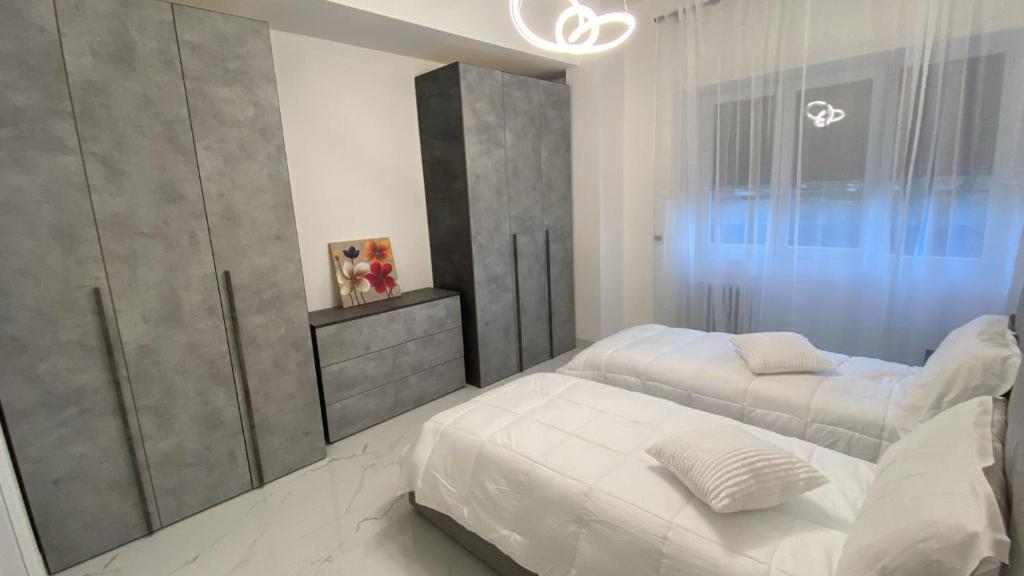 a bedroom with two beds and a mirror at Tiburtina Flats in Rome