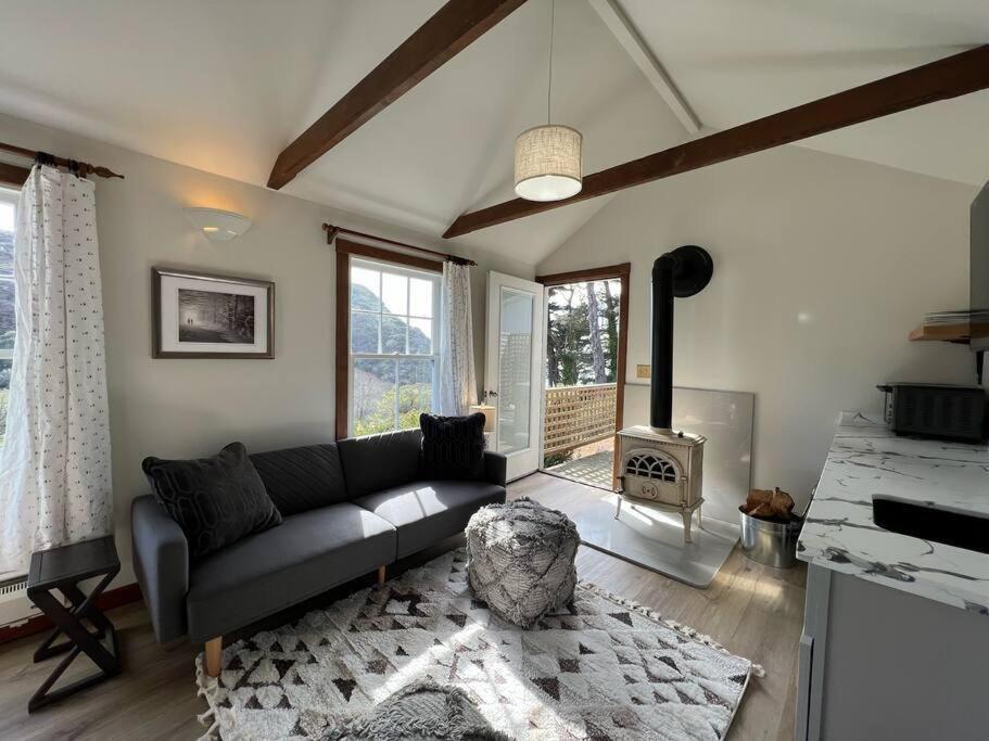 a living room with a couch and a fireplace at Boathouse Cottage (Historic Coast Guard property) in Point Arena