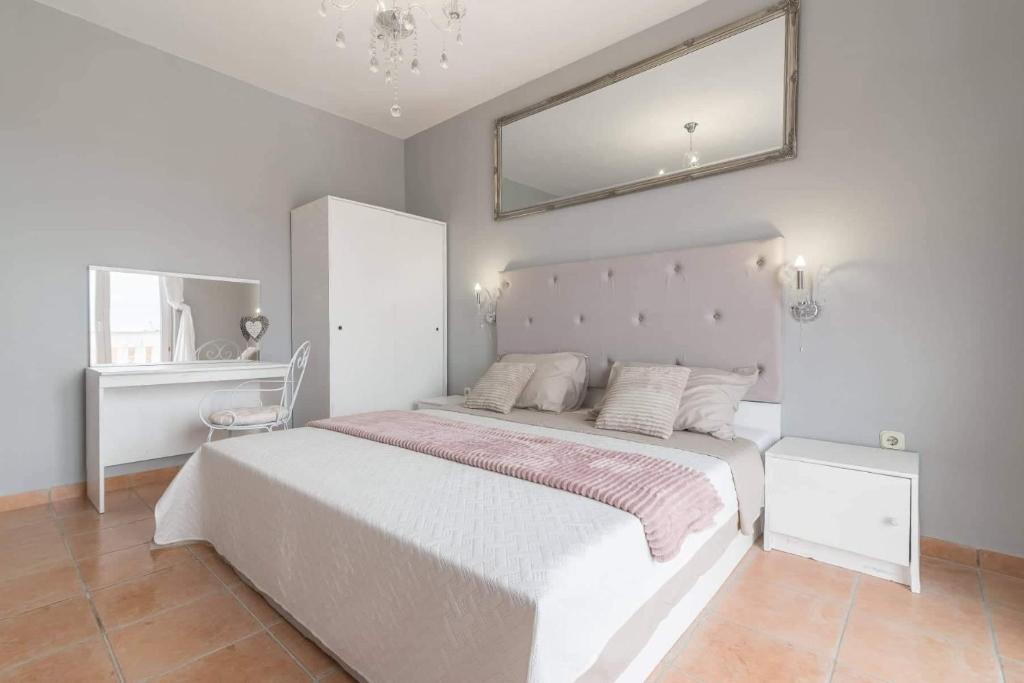 a bedroom with a large bed with a large mirror at Blue Lagoon in Potocnica