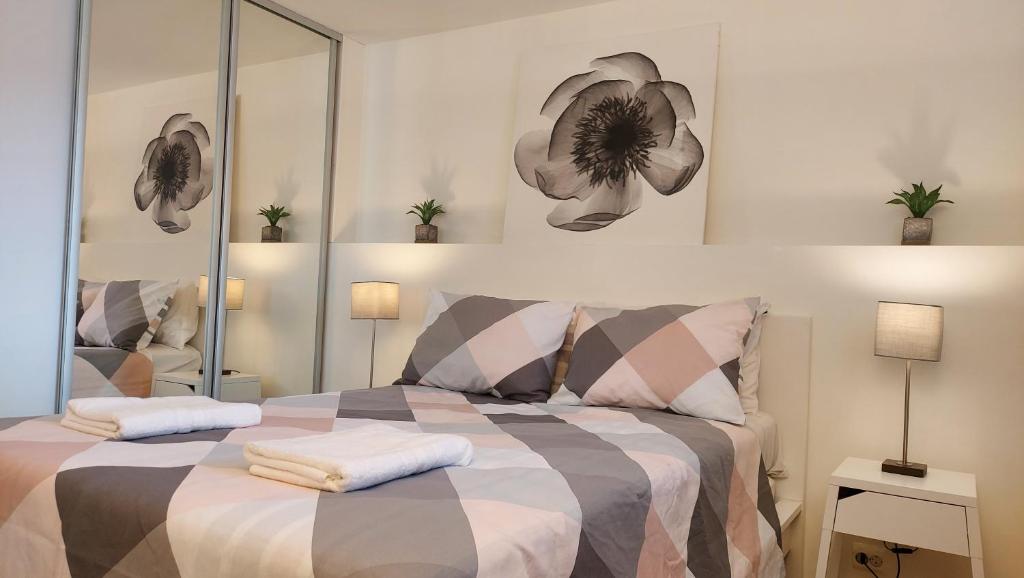a bedroom with a bed with two pillows on it at Central modern Lyse Fjord apartment in Stavanger