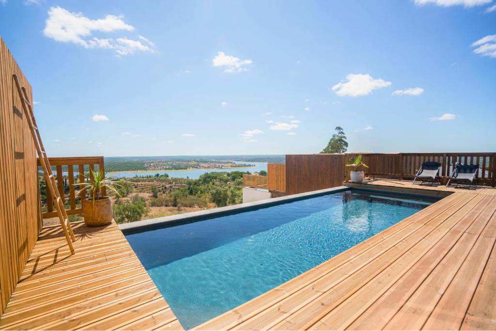 a swimming pool on the deck of a house at Caju Villas Montargil - Villa Terra Preta in Montargil