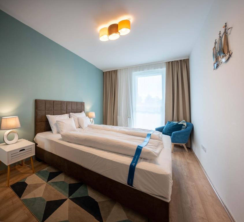 a bedroom with a large bed and a window at Kristall Home Apartment in Fonyód