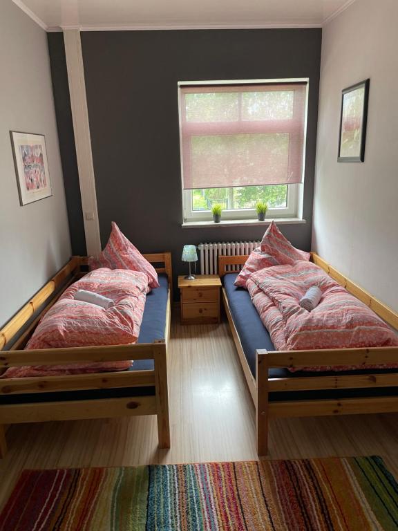 a bedroom with two beds and a window at Flat for up to 4 people in Dresden-Striesen in Dresden