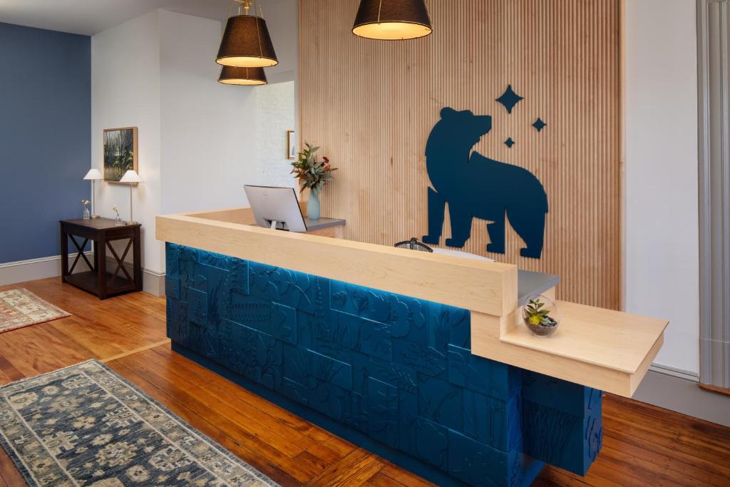 a lobby with a bear sign on the wall at Hotel Ursa in Orono