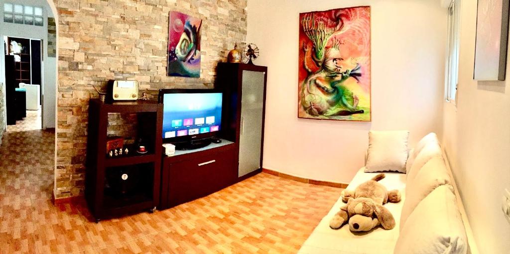 a living room with a teddy bear sitting on a couch at Toscal Nest in Santa Cruz de Tenerife