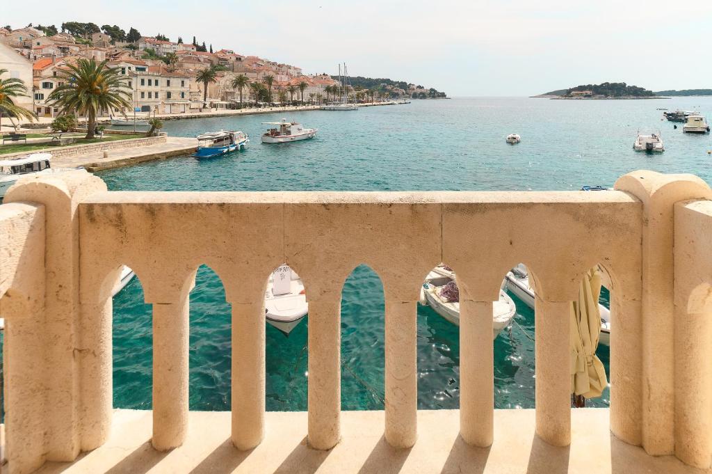 a view of the water from a balcony with boats at Apartment Mama Marija in Hvar
