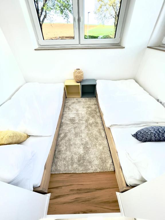 Postel nebo postele na pokoji v ubytování Tiny House Wettelsheim