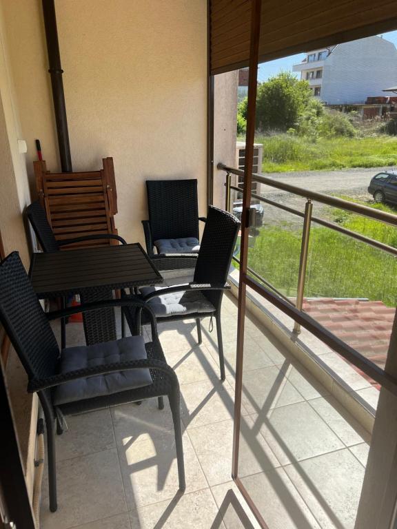 a balcony with chairs and a table on a porch at Частен апартамент Лагуна - Private Two-Bedroom Apartment Laguna in Primorsko