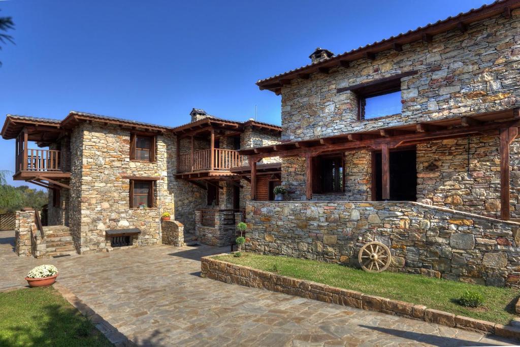 a large stone house with a patio in front of it at Petrina House in Ángistron
