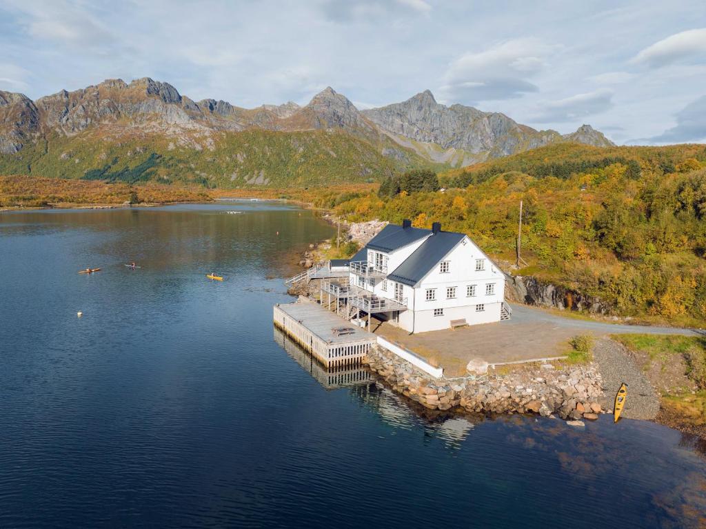 an aerial view of a house on a dock in a lake at Lofoten Apartments in Kabelvåg