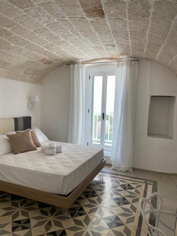 a bedroom with a large bed and a tv at Dimora Santa Teresa in Monopoli