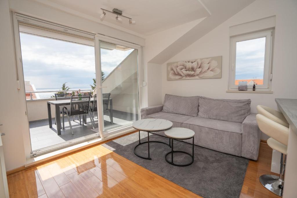 a living room with a couch and a table at Adriatic Escape Novalja-Zrce! in Novalja