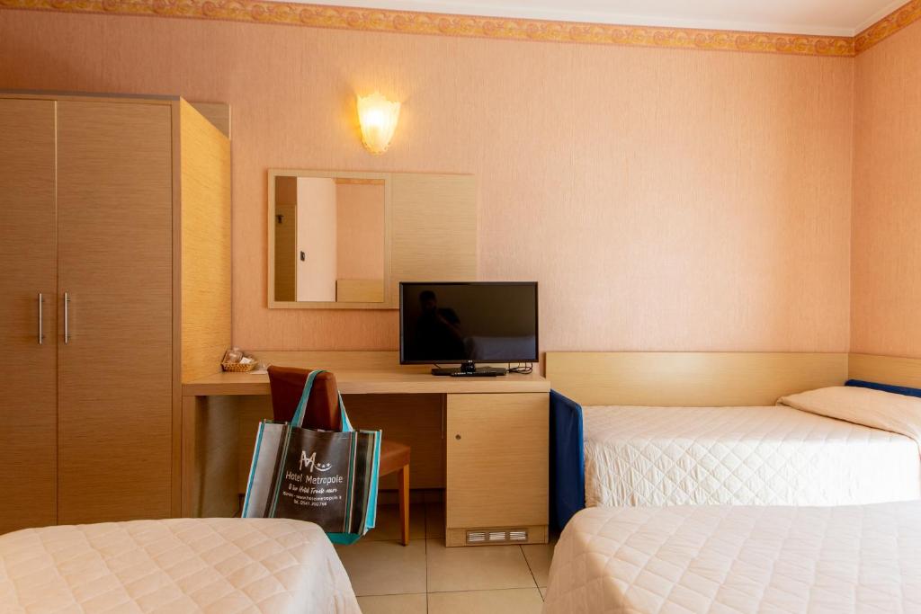Postel nebo postele na pokoji v ubytování Hotel Metropole