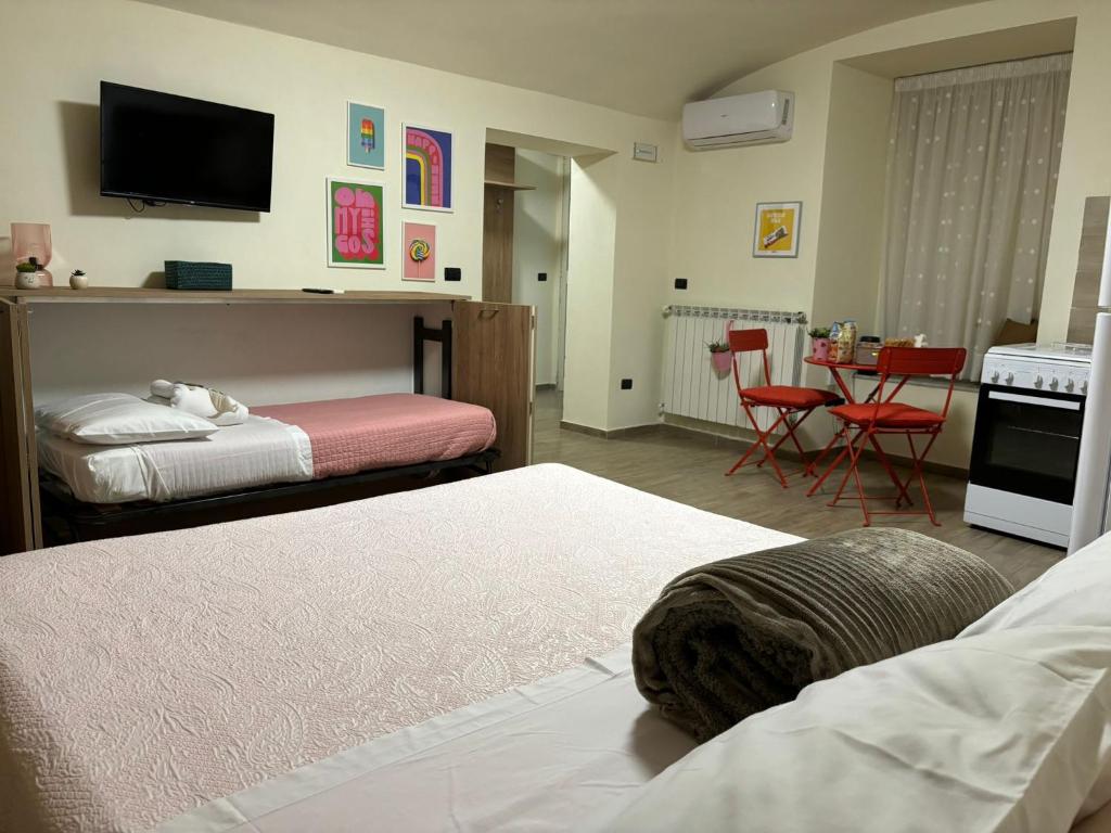a room with two beds and a table with chairs at MareLuna Guest House in Naples