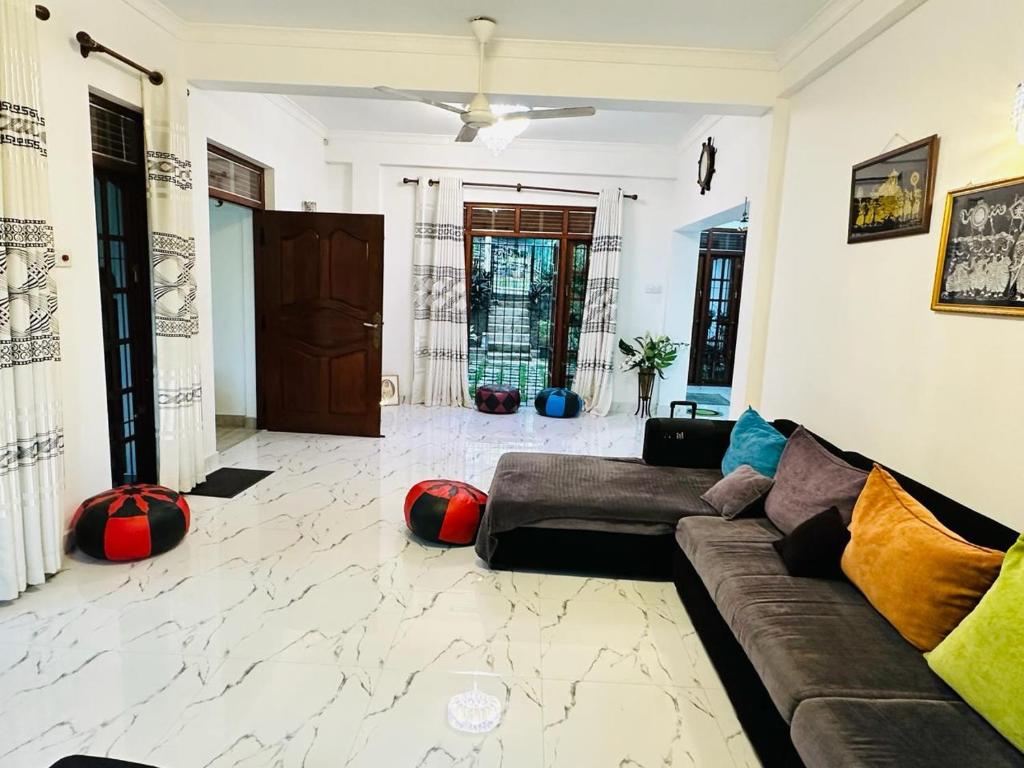 a living room with a couch sitting on a marble floor at The Residence in Kandy