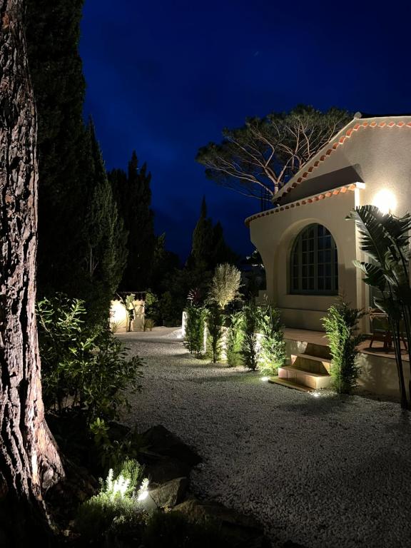 a house with lights on a driveway at night at Maison d'Orange - La Pinede in Saint-Tropez