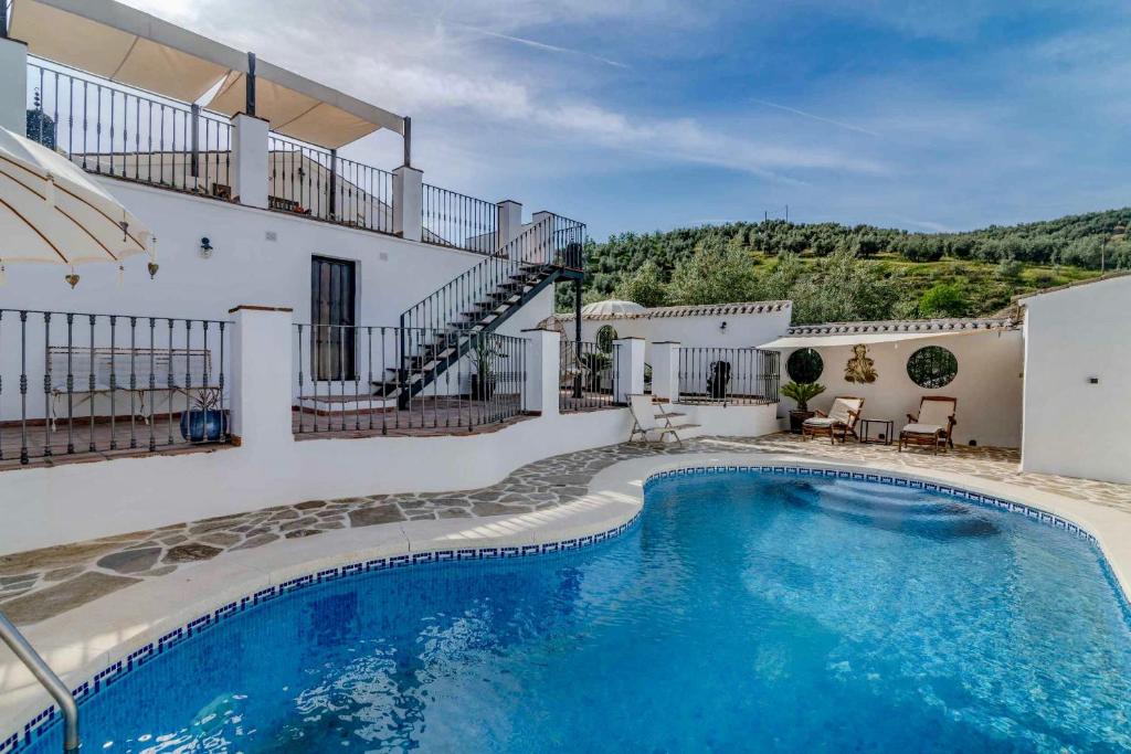 a swimming pool in front of a house at Casa Valle de Oro in Villanueva de Algaidas