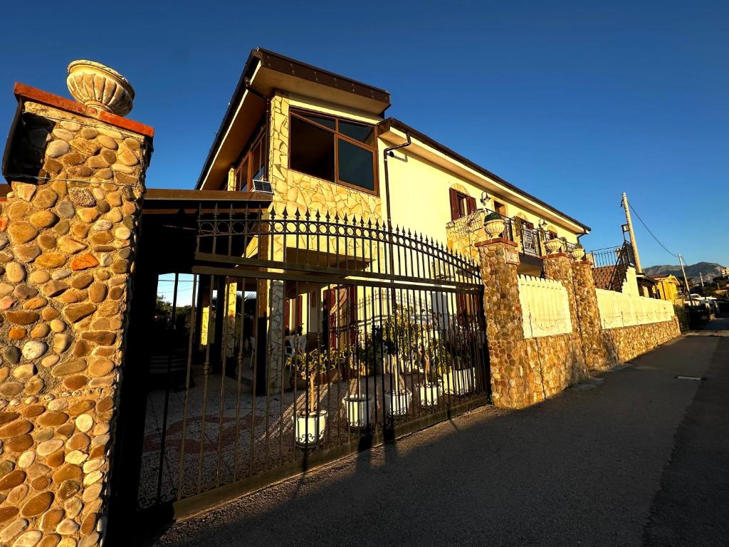 a building with a fence in front of it at Casa del Sole in Campofelice di Roccella