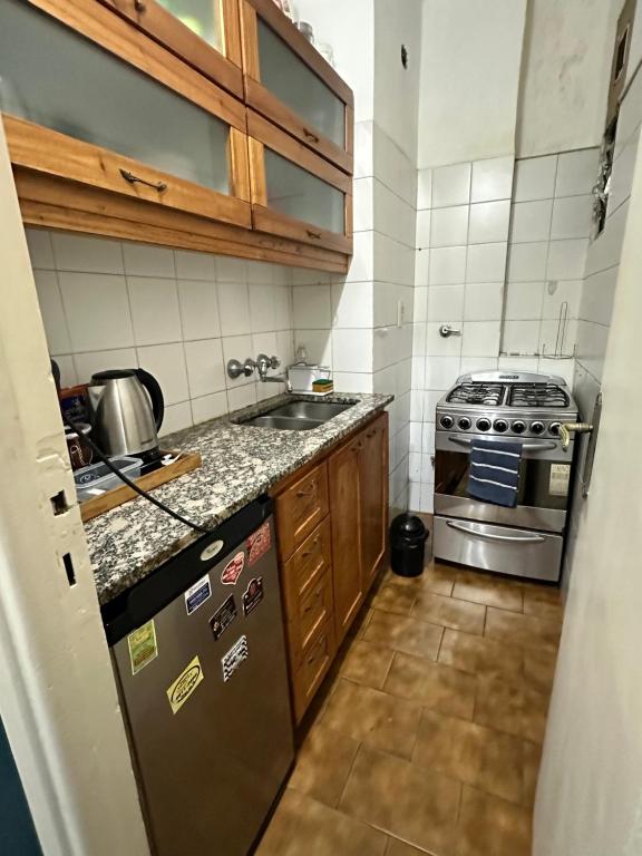 a small kitchen with a stove and a sink at Buenos Aires, Recoleta, Capital Federal in Buenos Aires