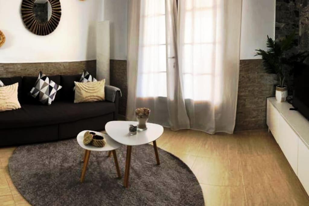 a living room with a couch and a table at Apartamento Casa el Canario in Costa Teguise