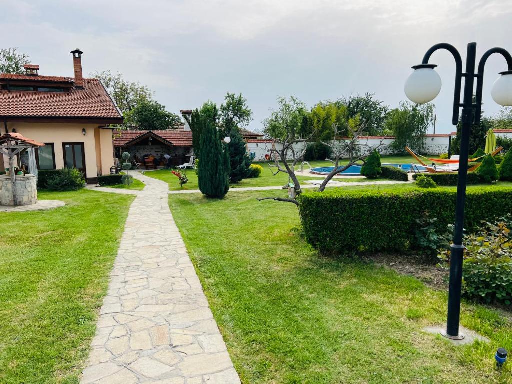 a walkway in a yard next to a house at Vila Teo in Vasil Levski