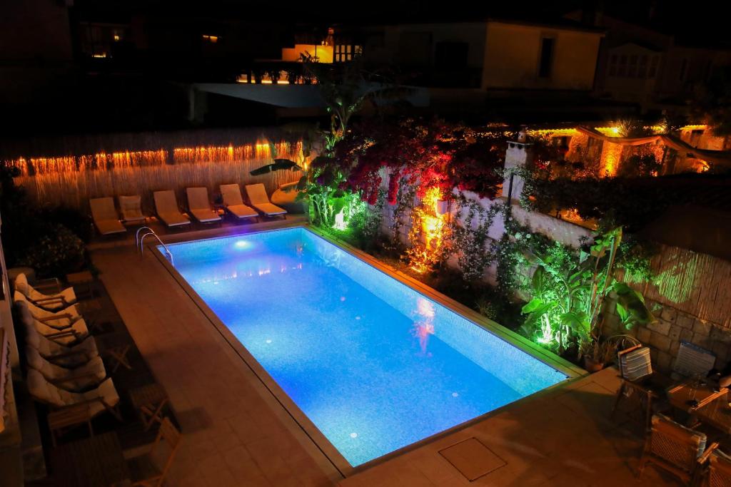 an overhead view of a swimming pool at night at Wind Of Alaçatı Adult Only 13 in Çeşme