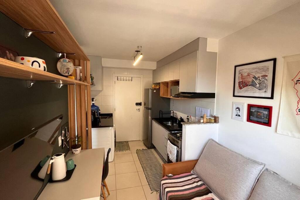 a kitchen with a couch and a table in a room at Estúdio a 500m Metro Joao Dias in Sao Paulo