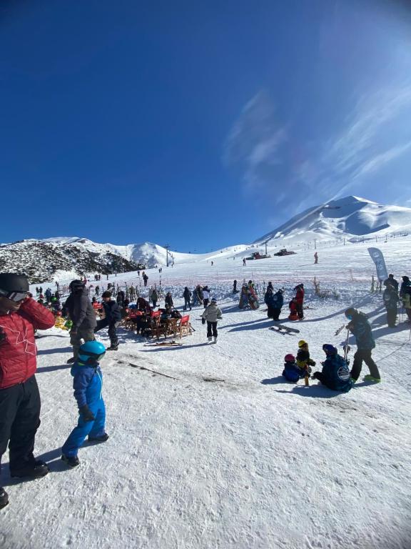 a group of people on a snow covered ski slope at Refugio en Malalcahuello in Malalcahuello