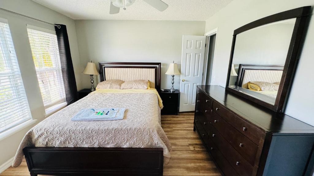 una camera con un letto e un grande specchio di 2 private rooms in a quiet neighborhood can book up to 4 people a Orlando