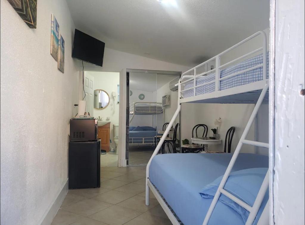 a bedroom with a bunk bed and a kitchen at B6 Best Value on Private Bedroom with Private Bathroom in Little Havana, Miami in Miami