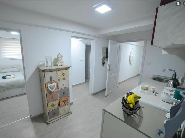 a kitchen with a counter with a banana in a basket at Hostel Tuzla in Tuzla