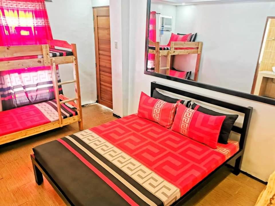 a room with a bed and two bunk beds at Aurum Hot Spring Resort in Los Baños