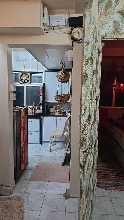 a kitchen with an open door to a kitchen with a table at Laxmi Happy Home in Pune in Pune