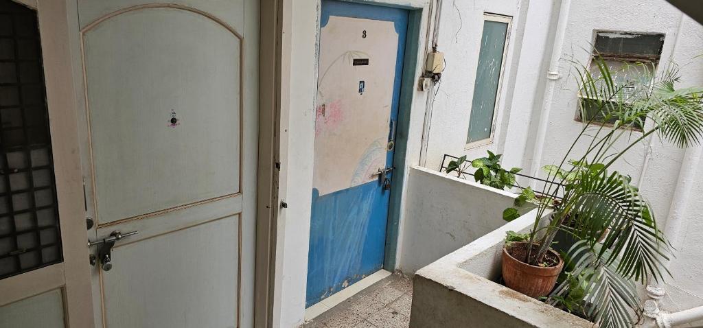 an open door of a house with plants next to it at Laxmi Happy Home in Pune in Pune