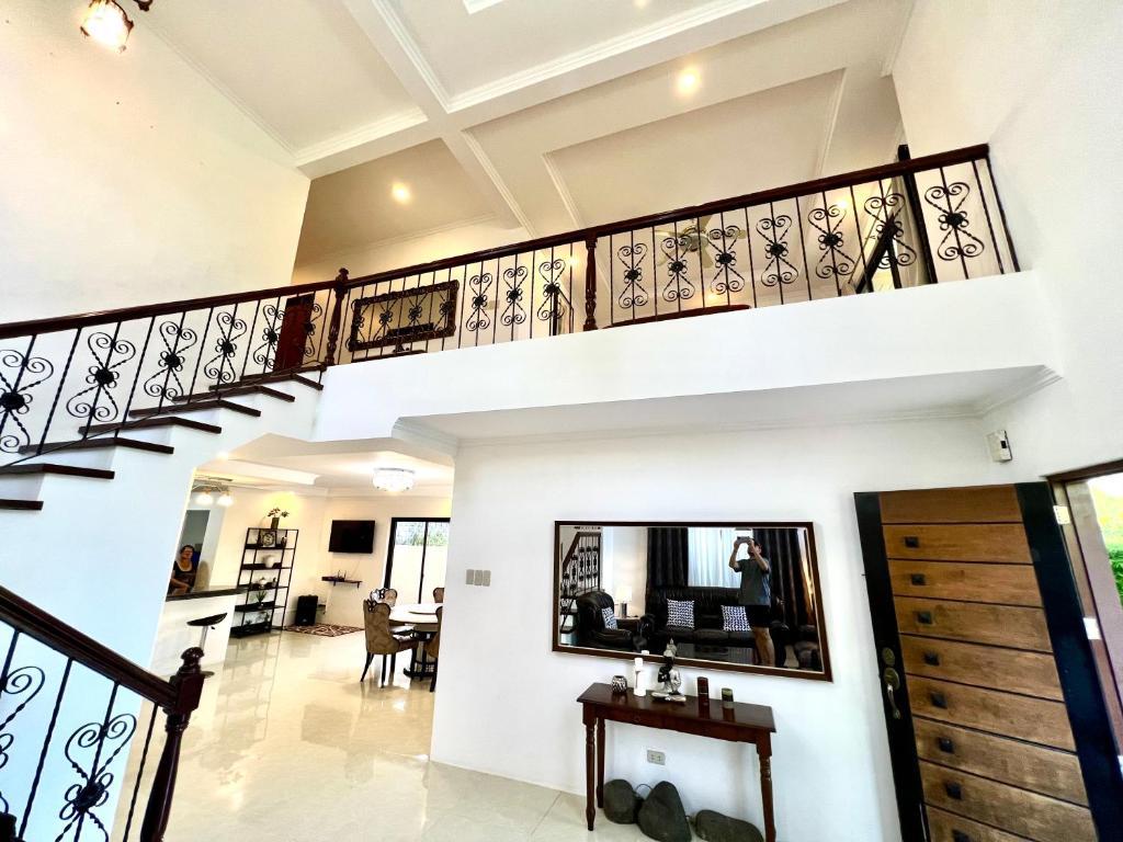a spiral staircase in a house with a living room at Sierra Pines Place Tagaytay in Tagaytay
