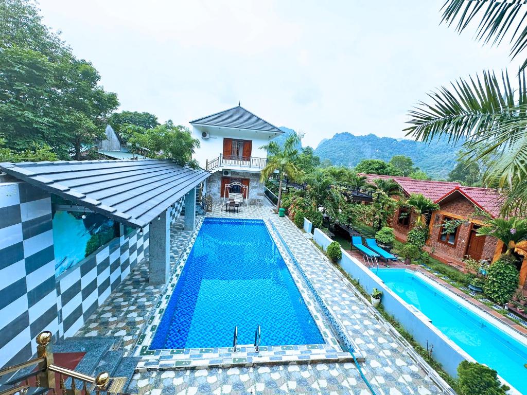 an overhead view of a swimming pool next to a house at The Hillside Homes in Phong Nha