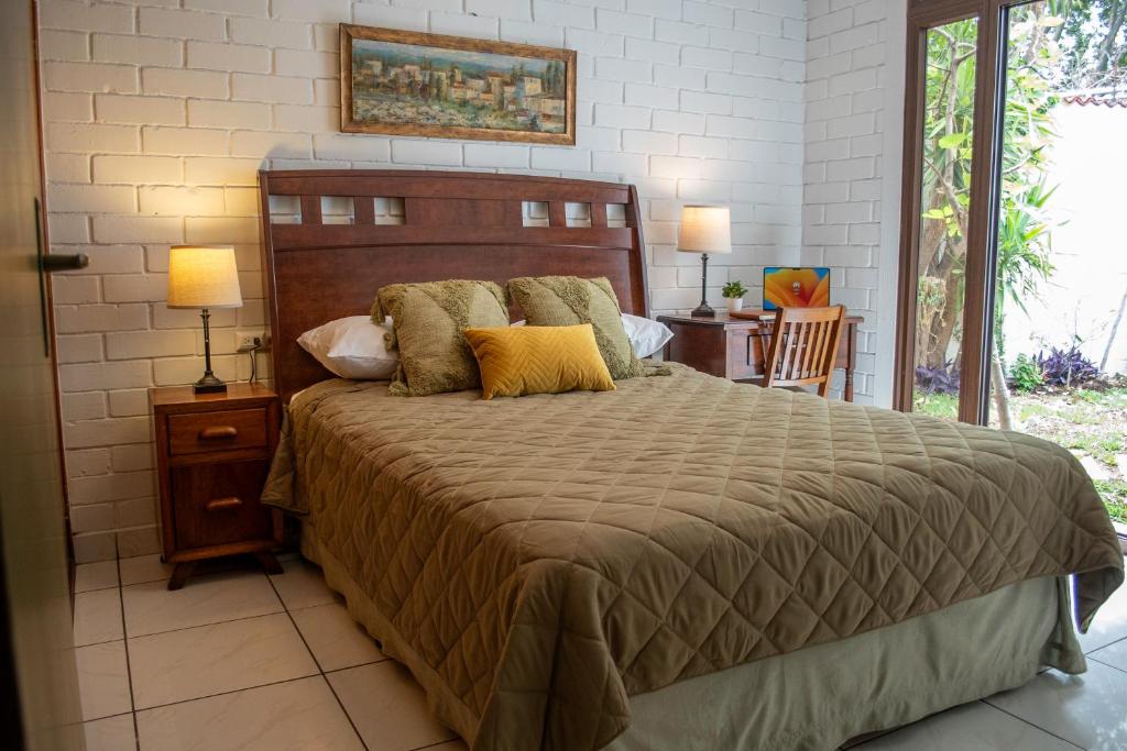 a bedroom with a large bed with pillows on it at Villa Nola in Guatemala