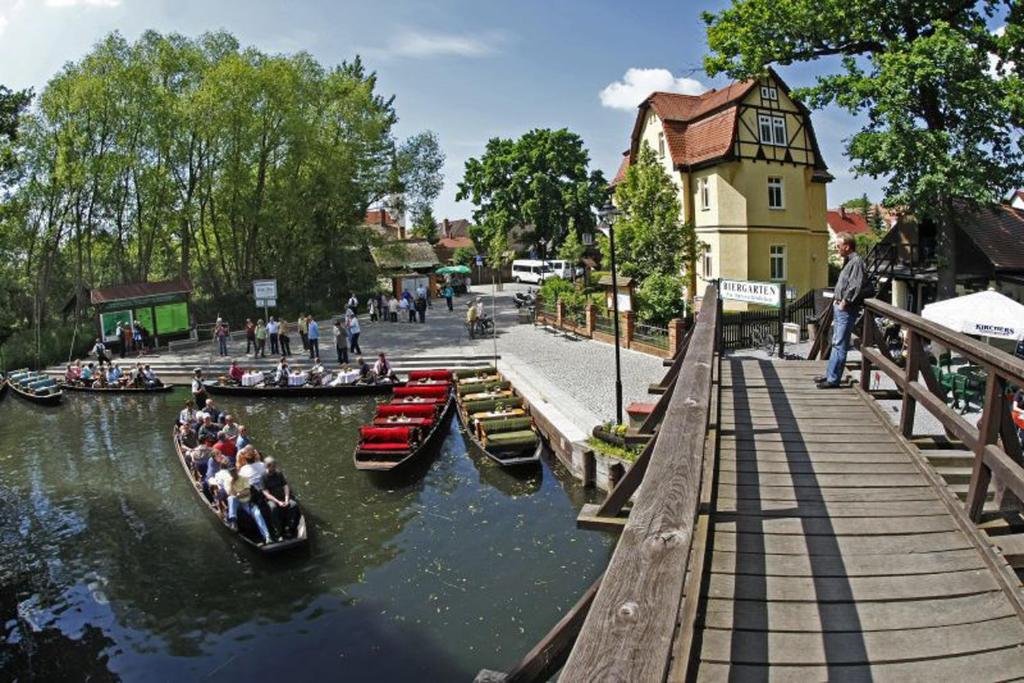 eine Gruppe von Menschen, die auf einem Fluss in Booten reiten in der Unterkunft Spreewald Pension Am Spreeschlößchen in Lübbenau