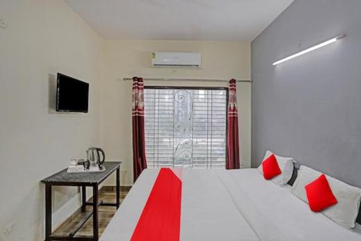a bedroom with a bed and a table and a window at Hotel The Royal Stay in Noida