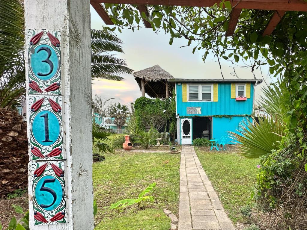 a house with a sign in front of it at Salty Dog Cottage in Surfside Beach