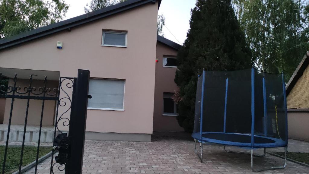 a blue chair in front of a house at Vikendica Nika in Palić