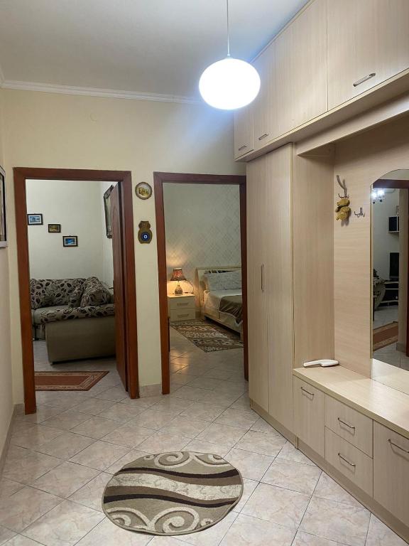 a room with a kitchen with a rug on the floor at apartment in the city center in Durrës