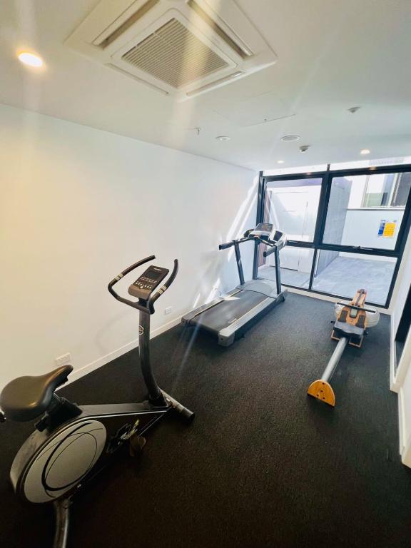 a gym with two treadmills and a treadmill at CASSA TOOWONG - Convenient 1B Apt at Central Location with Parking Managed by The Cassa in Brisbane