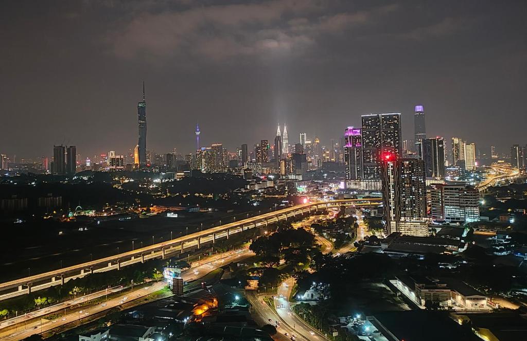 a city lit up at night with traffic on a freeway at Razak City Residence at Sungai Besi, Kuala Lumpur by Liberty Homes in Kuala Lumpur