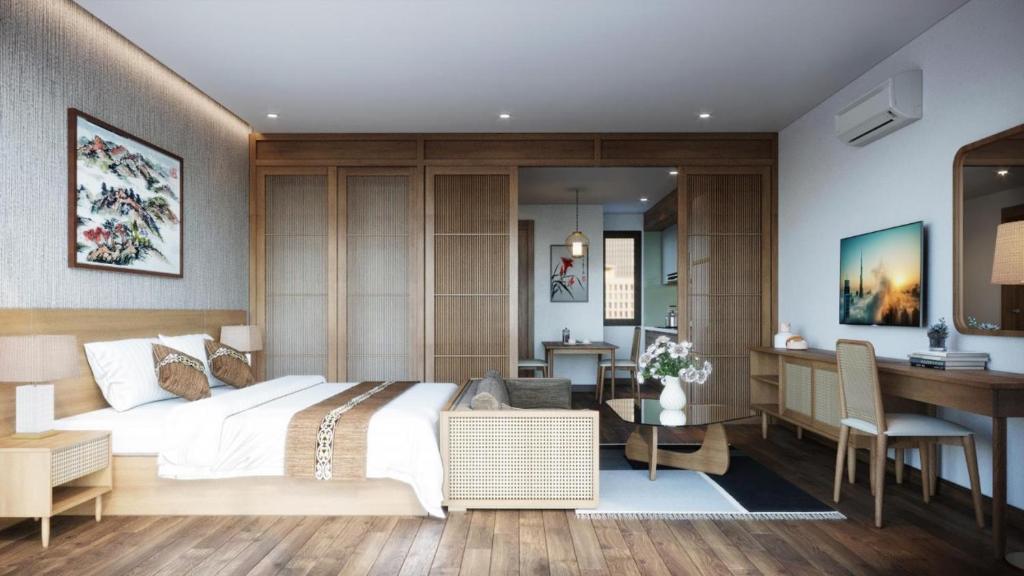 een slaapkamer met een groot bed en een bureau bij J'ADORE APARTMENT in Hanoi